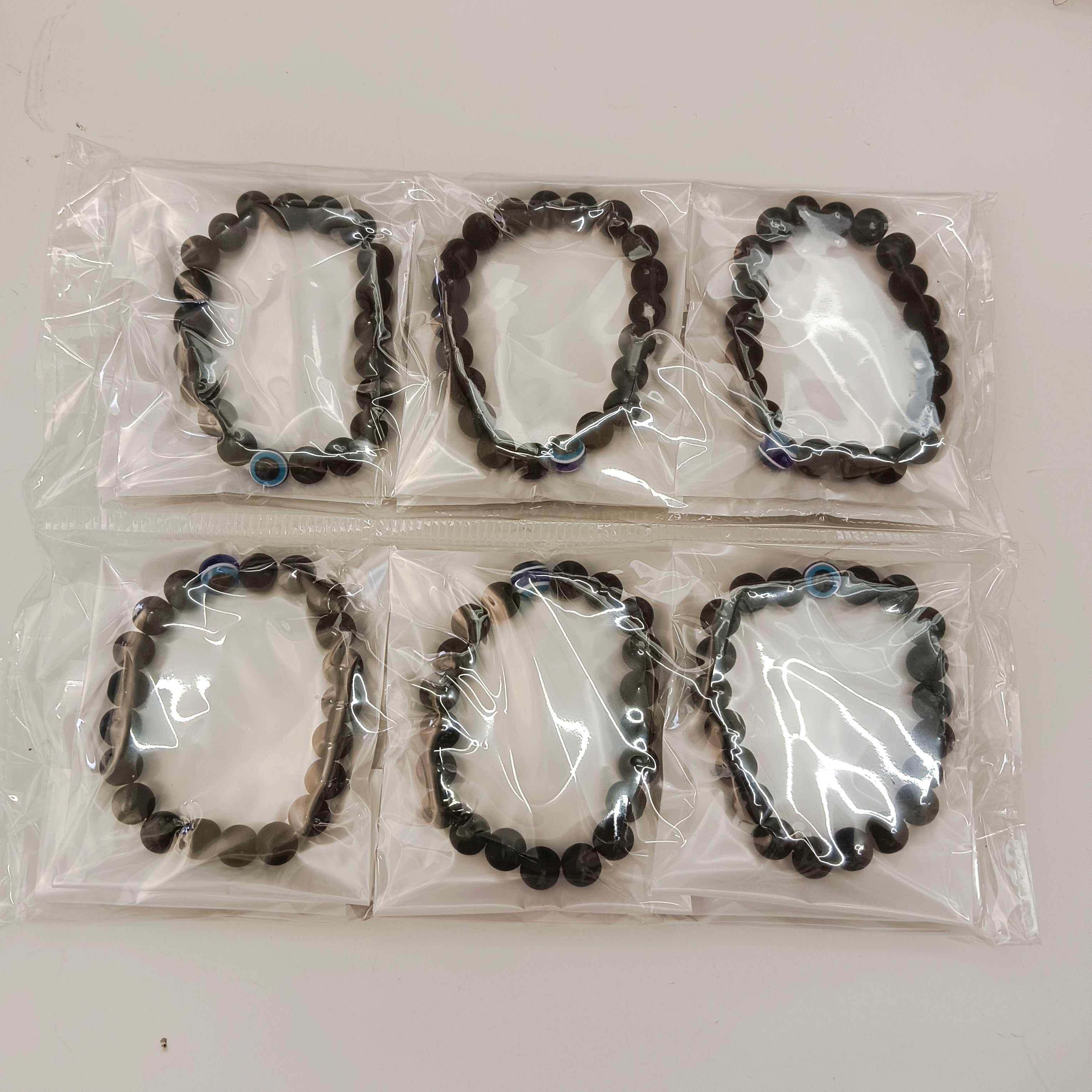 Urthn Evil Eye Black Beads Bracelet  (Set Of 12)