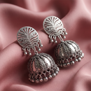 Urthn These oxidised silver jhumka earrings feature a floral stud for Women